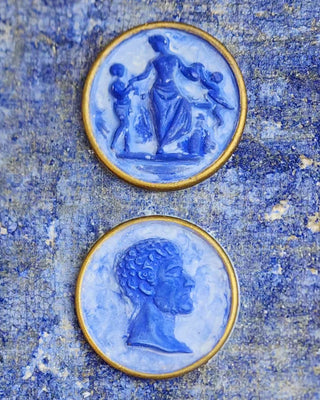 Capri Intaglio Patina Finish showing hand-cast CeramiCast intaglio medallions in Capri Sky blue with marbled stone depth and aged gilt rims by Amy Howard At Home