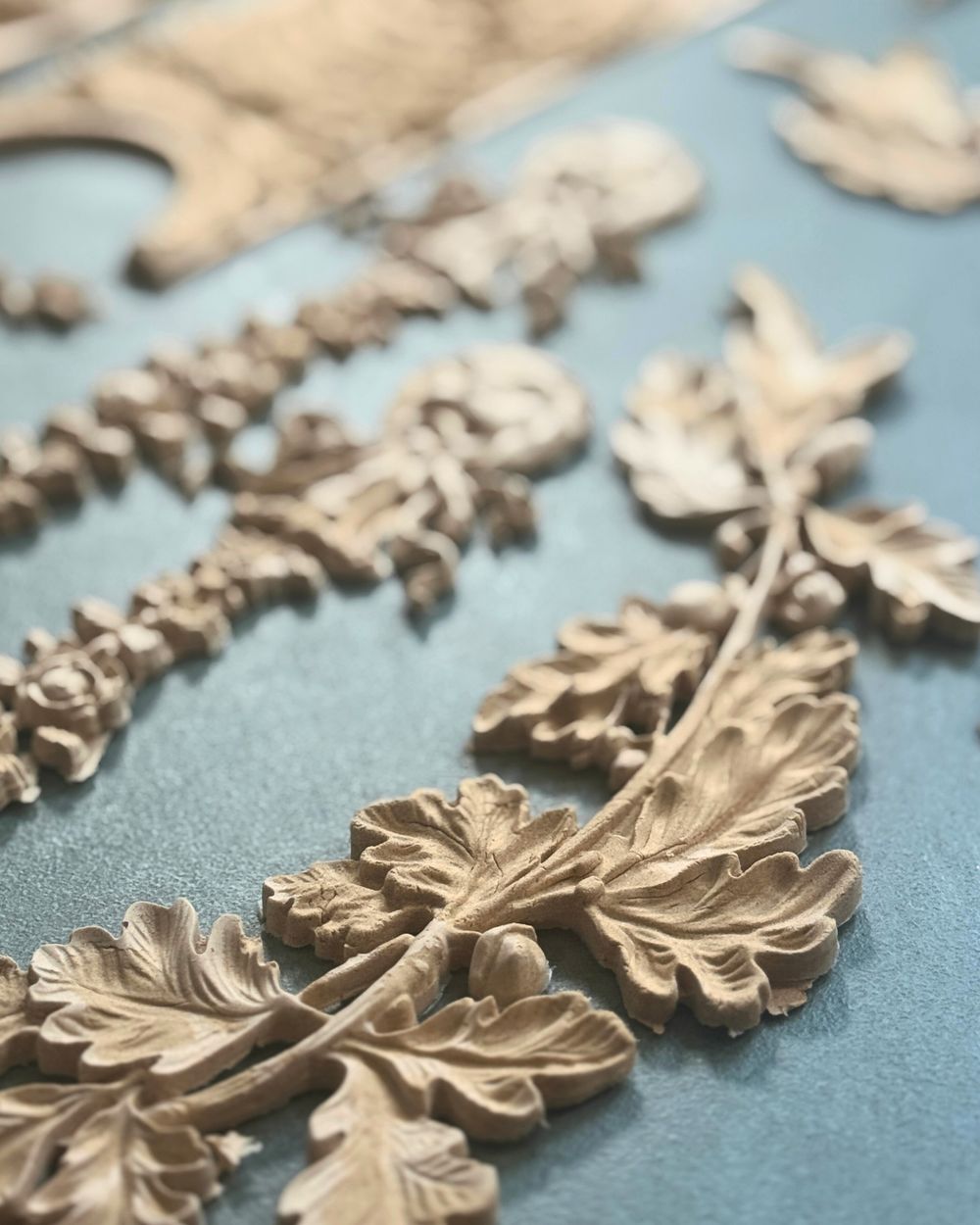Empire Silicone Mould featuring oak leaves and a classical urn design, used with WoodCast™ to create custom European-style decorative appliqués for furniture and cabinetry.