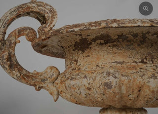 Pair of late 19th century cast iron Chambord garden planters with weathered white patina on a gray background.