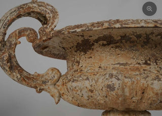 Pair of late 19th century cast iron Chambord garden planters with weathered white patina on a gray background.