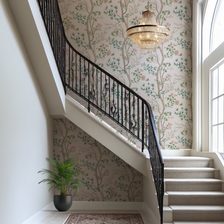 Staircase with decorative wallpaper and a chandelier in a home interior.