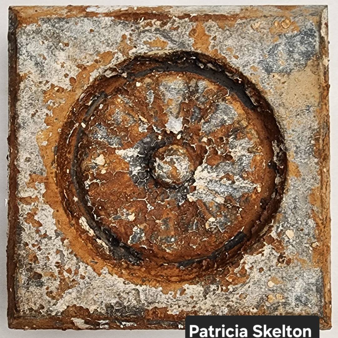 Weathered Finish with layered rusted patina and cracked texture on decorative surface.