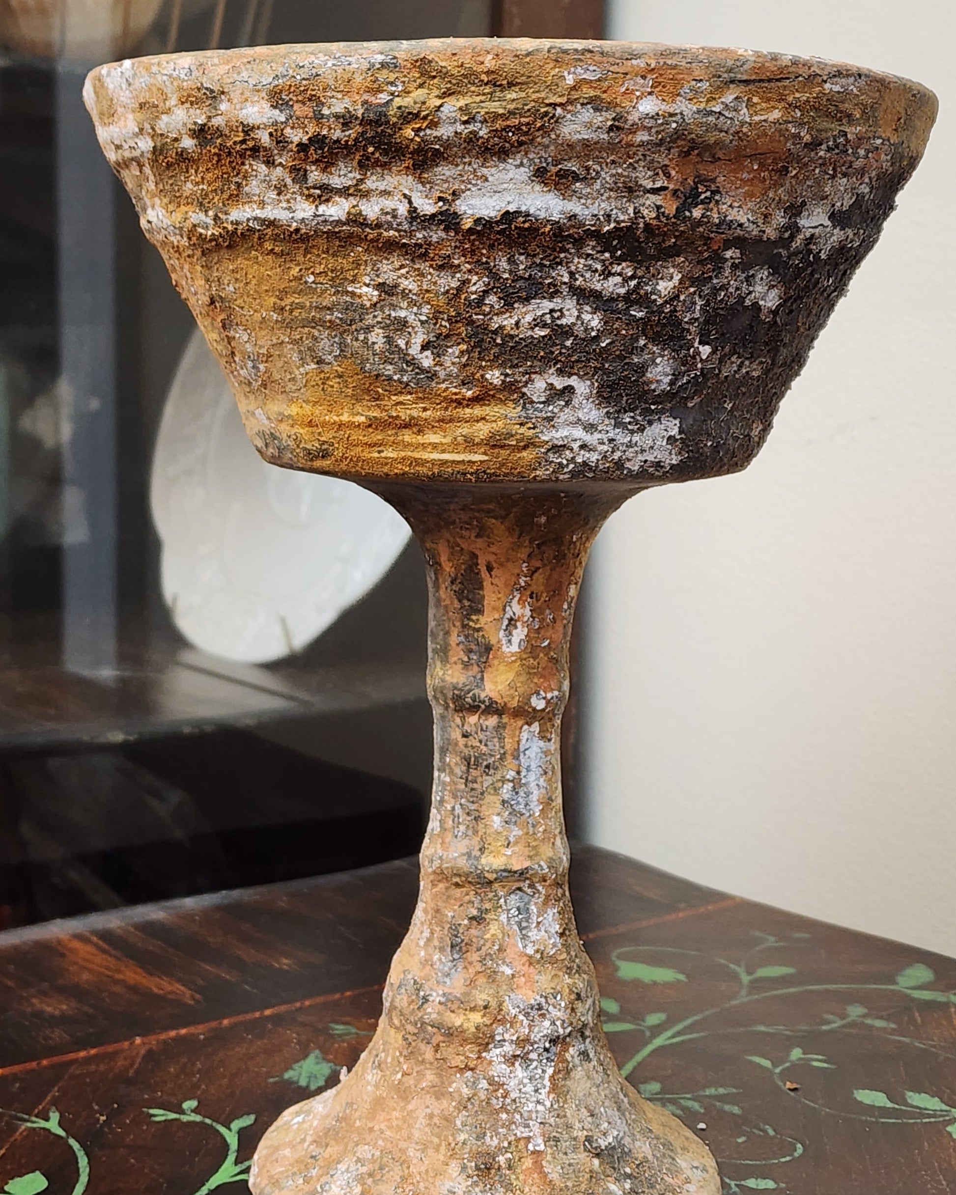 Weathered Finish with layered rusted patina and cracked texture on decorative surface.