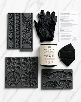 Amy Howard At Home WoodCast Beginner Bundle flat lay with moldable wood pulp tin Alexandria Tivoli and Acanthus silicone decorative moulds gloves mask and instructions