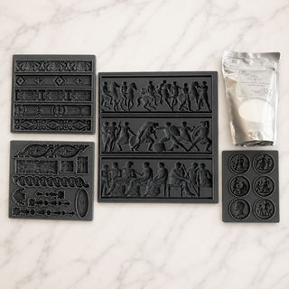 my Howard At Home Italian Mould Collection Bundle flat lay showing the Renaissance, Rolling Coin, Relief and Intaglio Decorative Silicone Moulds with a free CeramiCast on a marble surface